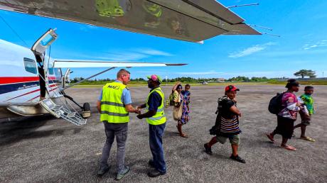 Passengers disembarking MAF aircraft