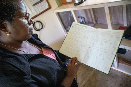 Loretta showing a ledger of the boat mishaps and persons lost at sea